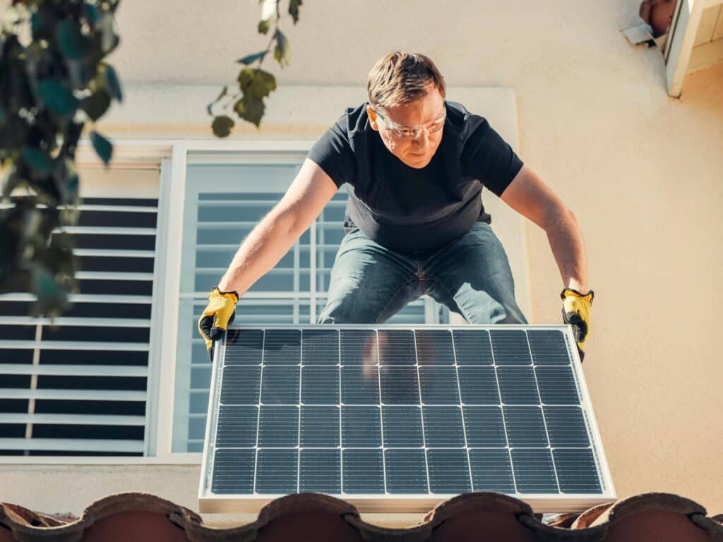 A man installing solar panel