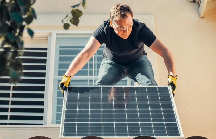 A man installing solar panel