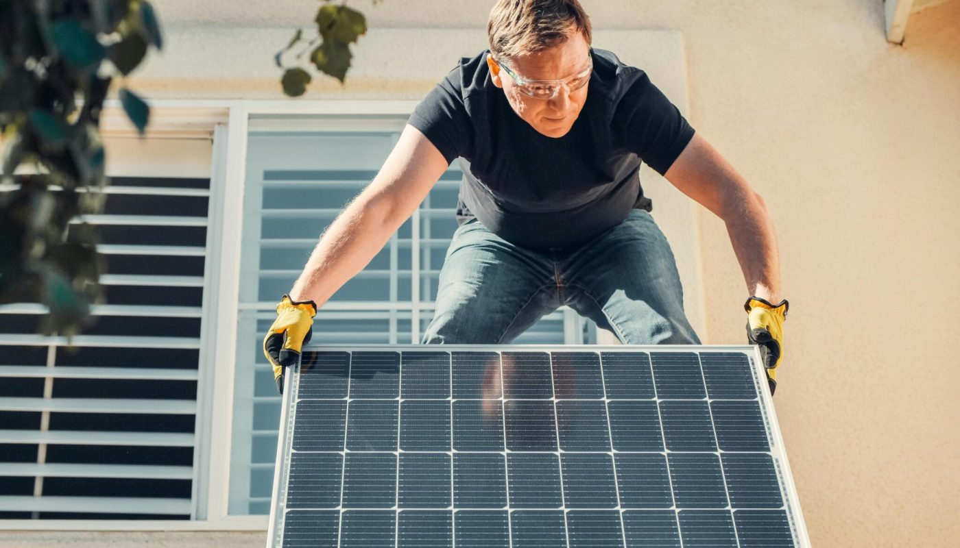 A man installing solar panel