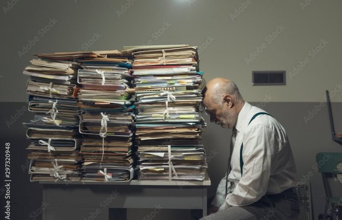Desperate business executive with lots of paperwork